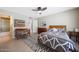 Bright bedroom with a ceiling fan, tile floors, and a picture window with natural light at 5429 N 78Th St, Scottsdale, AZ 85250