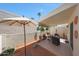 Inviting covered patio with tile flooring, a sun umbrella, and views of the landscaped backyard at 5429 N 78Th St, Scottsdale, AZ 85250