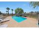 Sparkling community pool with surrounding lounge area, lush trees, and clear blue skies at 5429 N 78Th St, Scottsdale, AZ 85250