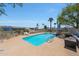 Community pool surrounded by lounge chairs and lush palm trees, perfect for relaxation and recreation at 5429 N 78Th St, Scottsdale, AZ 85250