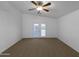 Bright, airy bedroom with neutral carpet and sliding glass doors at 573 W Rattlesnake Pl, Casa Grande, AZ 85122