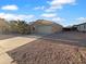 Charming single-story home featuring desert landscaping, a two-car garage, and mature palm trees at 573 W Rattlesnake Pl, Casa Grande, AZ 85122