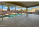 A view of the serene pool area from the covered patio at 573 W Rattlesnake Pl, Casa Grande, AZ 85122