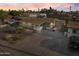 An aerial view of a charming single-story home with an extended driveway and basketball hoop at dusk at 6627 W Keim Dr, Glendale, AZ 85301