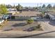 An aerial view of a charming single-story home with a minimalist rock garden and extended driveway at 6627 W Keim Dr, Glendale, AZ 85301