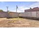 Wide-angle view of backyard with a storage shed and fence line offering a private space, ready for landscaping at 6627 W Keim Dr, Glendale, AZ 85301