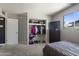 Bedroom with walk-in closet, TV and dresser offers comfortable space at 6627 W Keim Dr, Glendale, AZ 85301