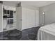 Bedroom with built in storage, connecting to the kitchen, features a unique black marble-patterned floor at 6627 W Keim Dr, Glendale, AZ 85301