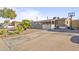 Charming single-story home with a minimalist rock garden and extended driveway at 6627 W Keim Dr, Glendale, AZ 85301