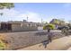 Charming single-story home with a minimalist rock garden featuring drought-resistant plants at 6627 W Keim Dr, Glendale, AZ 85301