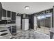 Bright kitchen with black cabinets, white appliances, and a sliding glass door leading to the outdoor space at 6627 W Keim Dr, Glendale, AZ 85301