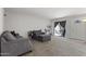 Comfortable living room with gray sofas, and a sliding door leading to a patio area at 6627 W Keim Dr, Glendale, AZ 85301