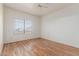 Bright, vacant bedroom shows wood floor, window, and neutral walls at 6770 N 47Th Ave # 1022, Glendale, AZ 85301