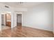 Neutral bedroom with wood floors, ceiling fan, and entrance to bathroom at 6770 N 47Th Ave # 1022, Glendale, AZ 85301