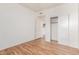 Spare room showing a sliding door closet, wood floor, and an open entrance to the kitchen at 6770 N 47Th Ave # 1022, Glendale, AZ 85301