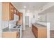 Bright kitchen featuring wood cabinets, white appliances, and a convenient breakfast bar at 6770 N 47Th Ave # 1022, Glendale, AZ 85301