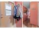 The pink hallway features several wall hangings and a door to the outside at 701 S Dobson Rd # 432, Mesa, AZ 85202