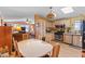 Open eat-in kitchen connected to the living room featuring laminate flooring and an open layout at 701 S Dobson Rd # 432, Mesa, AZ 85202