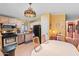 Well-lit kitchen with light cabinets, a stainless steel dishwasher, and a dining area with seating at 701 S Dobson Rd # 432, Mesa, AZ 85202