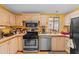 Well-equipped kitchen featuring stainless steel appliances and light wood cabinets at 701 S Dobson Rd # 432, Mesa, AZ 85202