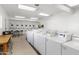 Clean and brightly lit community laundry room has rows of modern washing machines for residents' convenience at 701 S Dobson Rd # 432, Mesa, AZ 85202