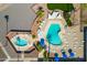 Aerial view of community pools and lounge areas with shade canopies and mature palm trees at 701 S Dobson Rd # 432, Mesa, AZ 85202