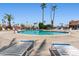 Inviting community pool with ample lounge chairs and palm trees, perfect for relaxation at 701 S Dobson Rd # 432, Mesa, AZ 85202