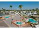 Aerial view of community pools and spas with lounge chairs and well-maintained landscaping at 701 S Dobson Rd # 432, Mesa, AZ 85202