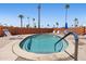 Relaxing spa with blue tile accents, surrounded by a brick privacy wall and lounge seating at 701 S Dobson Rd # 432, Mesa, AZ 85202