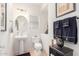 Cozy powder room featuring a pedestal sink, decorative mirror, and dark wood accents at 8429 W Vernon Ave, Phoenix, AZ 85037