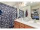 Double vanity bathroom with Eiffel tower shower curtain and good lighting at 8429 W Vernon Ave, Phoenix, AZ 85037