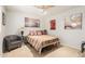 Comfortable bedroom with a cozy armchair and a stylish bed at 8429 W Vernon Ave, Phoenix, AZ 85037