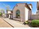 Side view of a stucco home with an arched window and desert landscaping at 8429 W Vernon Ave, Phoenix, AZ 85037