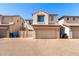 Two-story townhome with a tan stucco exterior, tile roof, and a two car garage at 8429 W Vernon Ave, Phoenix, AZ 85037