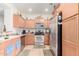 Well-lit kitchen featuring wooden cabinets and stainless steel appliances at 8429 W Vernon Ave, Phoenix, AZ 85037