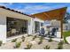 Inviting backyard patio with outdoor kitchen, pergola, and well-maintained desert landscape at 10013 N 106Th Pl, Scottsdale, AZ 85258