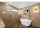 Modern bathroom featuring a freestanding tub, walk-in shower, and stylish fixtures at 10013 N 106Th Pl, Scottsdale, AZ 85258