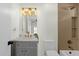 Charming bathroom featuring a vanity with stylish lighting and a tiled shower at 10013 N 106Th Pl, Scottsdale, AZ 85258