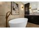 This bathroom showcases a modern tub and vanity with contemporary fixtures and lighting at 10013 N 106Th Pl, Scottsdale, AZ 85258