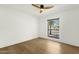 Minimalist bedroom with a ceiling fan and large window showing the outside landscape at 10013 N 106Th Pl, Scottsdale, AZ 85258