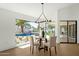 Dining area with a glass-top table and view of the pool through a large window at 10013 N 106Th Pl, Scottsdale, AZ 85258