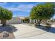 Home with a long driveway, attached garage, desert landscaping, and a well-manicured lawn at 10013 N 106Th Pl, Scottsdale, AZ 85258