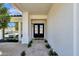 Close-up of the front door with black frame, and desert landscaping at 10013 N 106Th Pl, Scottsdale, AZ 85258