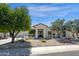 Charming single-story home featuring desert landscaping, mature trees, and a stucco exterior at 10013 N 106Th Pl, Scottsdale, AZ 85258