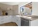 Kitchen boasts white cabinets, stainless steel appliances, and a farmhouse sink at 10013 N 106Th Pl, Scottsdale, AZ 85258