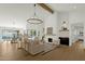 Open-concept living space with a fireplace, wood beam, and view of the outdoor pool at 10013 N 106Th Pl, Scottsdale, AZ 85258