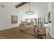 Comfortable living room with wood beam, a view to the pool, and stylish decor at 10013 N 106Th Pl, Scottsdale, AZ 85258