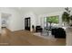 Sunlit living room featuring hardwood floors and stylish contemporary furniture at 10013 N 106Th Pl, Scottsdale, AZ 85258