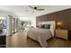 Spacious main bedroom features a decorative wall, ceiling fan, and access to the backyard at 10013 N 106Th Pl, Scottsdale, AZ 85258
