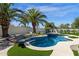 A stunning backyard features a freeform pool, lush landscaping, and provides a serene outdoor retreat at 10013 N 106Th Pl, Scottsdale, AZ 85258